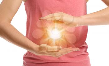 Meditating woman with ball of shining energy on white background�
