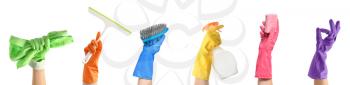 Female hands in gloves with cleaning supplies on white background�