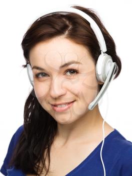 Closeup portrait of lovely young woman talking to customers as a consultant using headset, isolated over white
