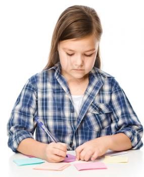 Girl is writing on color stickers using pen, planning concept, self-organization, isolated over white