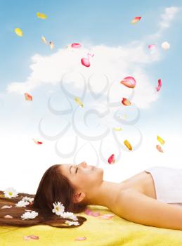 Royalty Free Photo of a Woman on a Massage Table With Daisies and Petals