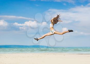 Royalty Free Photo of a Leaping Woman at the Beach