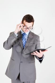 Portrait of handsome young businessman with notebook