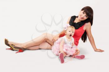 Beautiful happy mother with funny baby daughter 