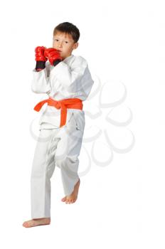 young boy aikido fighter in white kimono showing martial arts isolated on white
