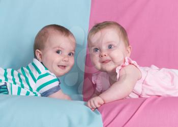 Beautiful twins on pink and blue.Brother and sister