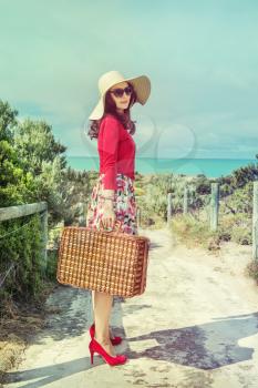 beautiful lady in red  near the sea in retro style 