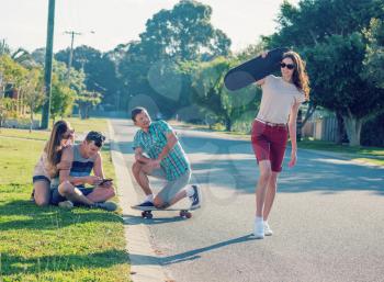 Group of young people having fun together outdoors  in evening light with retro vintage old instagram style toned