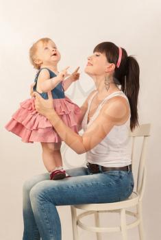 young happy mother with baby daughter in retro toning