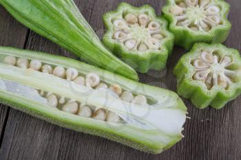  fresh  okra  vegetable also known as  lady's fingers on old wooden background