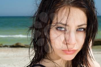 Royalty Free Photo of a Closeup of a Woman With a Beach in the Background