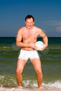 Royalty Free Photo of a Man With a Ball at the Beach