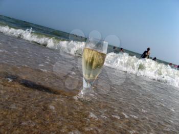Royalty Free Photo of a Glass of Champagne in the Ocean
