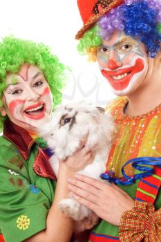Royalty Free Photo of a Couple of Clowns With a Rabbit