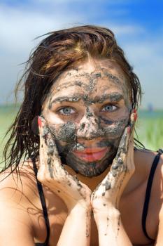Royalty Free Photo of a Woman With Mud on Her Face