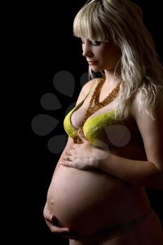 Royalty Free Photo of a Pregnant Woman in a Bra