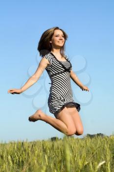 Royalty Free Photo of a Girl Jumping in a Field