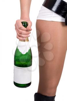 Royalty Free Photo of a Woman's Bare Leg and a Bottle of Champagne