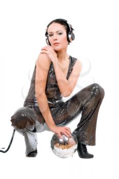 Young brunette in headphones with a mirror ball