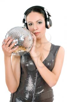 Sexy young woman in headphones with a mirror ball. Isolated on white