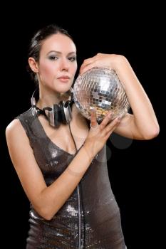 Portrait of brunette with a mirror ball in her hands. Isolated on black
