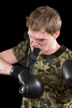Furious young man in boxing gloves. Isolated