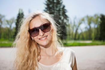 Portrait of pretty blond girl wearing sunglasses