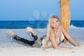Sexy young blonde lying on the sand