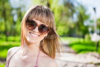Portrait of pretty smiling woman wearing sunglasses