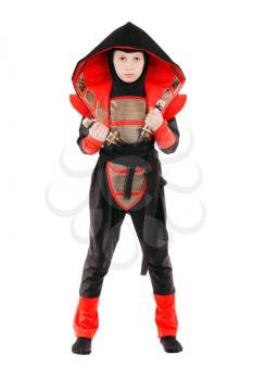 Little boy wearing ninja costume and posing with swords. Isolated on white