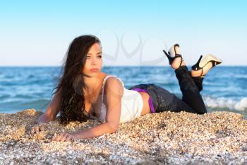 Pretty young brunette lying on the beach