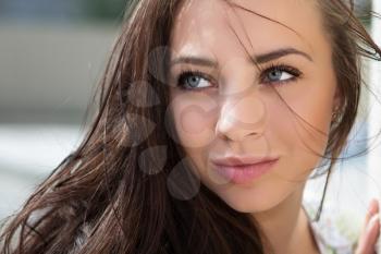 Close-up of attractive thoughtful brunette with plump lips