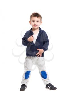 Playful little boy posing in sport clothes. Isolated on white