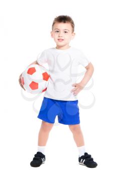 Nice little boy posing in football uniform with ball. Isolated on white