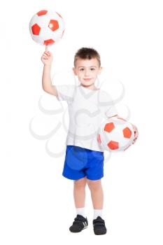 Little football player holding the ball on his finger. Isolated