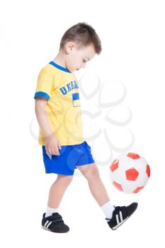 Nice little Ukrainian footballer playing with a ball. Isolated on white