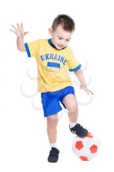 Nice little Ukrainian boy playing in football. Isolated on white