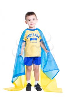 Nice little Ukrainian boy wrapped in the flag of his country. Isolated on white