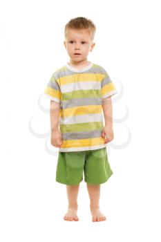 Nice blond boy posing in t-shirt and shorts. Isolated on white
