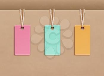Vector illustration of blank price tags in three different colors over paper background