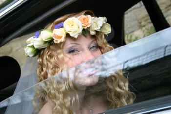 Royalty Free Photo of a Bride Sitting in a Vehicle