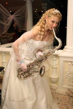 Royalty Free Photo of a Bride Playing a Saxophone