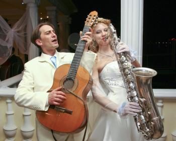 Royalty Free Photo of a Bride and Groom Playing Instruments