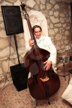 Royalty Free Photo of a Groom Playing the Bass