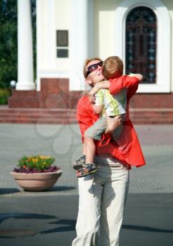 Royalty Free Photo of a Mother Carrying Her Son