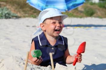 Royalty Free Photo of a Little Boy Playing on the Beach