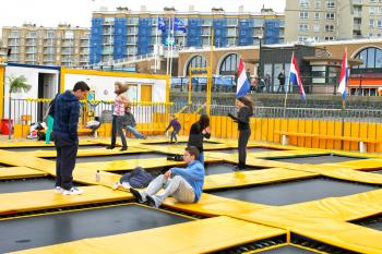 Young people jumping on a trampoline. The Hague. The beach of Scheveningen, Netherlands