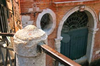 Railings of the old bridge over a canal in Venice, Italy
