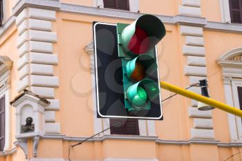 Traffic lights at the crossroads of the city is lit green