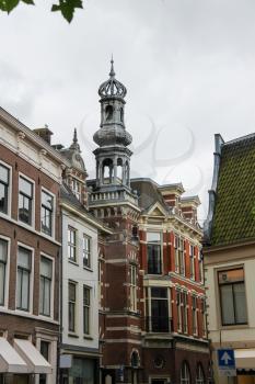 Old tower with a spire in the historic center of Haarlem, the Netherlands